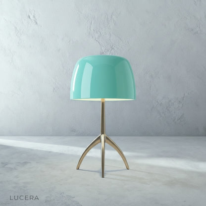 Albescent Table Lamp glowing at dusk on a patio side table with outdoor lounge furniture