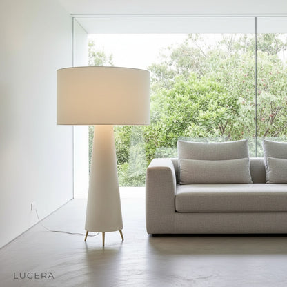 Quarters Floor Lamp glowing warmly in a cozy modern living room corner with fabric shade and mushroom silhouette