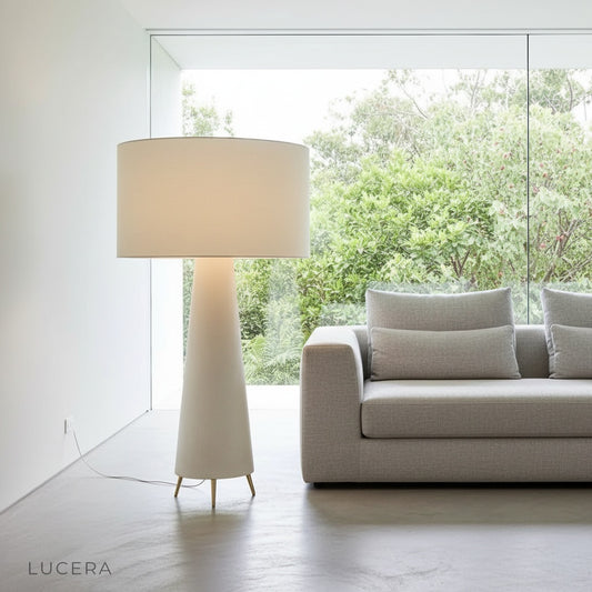 Quarters Floor Lamp glowing warmly in a cozy modern living room corner with fabric shade and mushroom silhouette