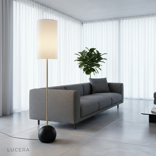 Adorn Floor Lamp with cylindrical fabric shade beside a cozy armchair in a bright living room