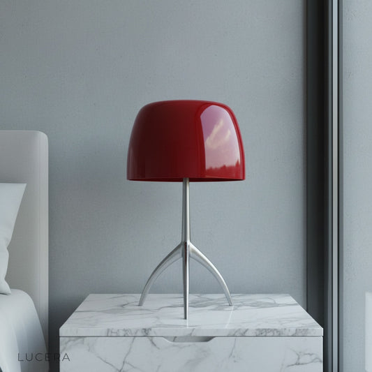 Albescent Table Lamp glowing warmly on a mid-century modern bedside table in a cozy bedroom