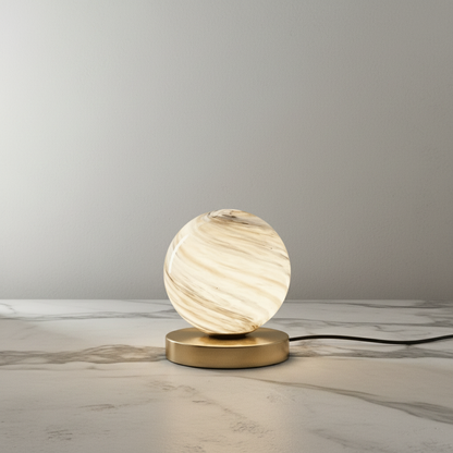 Jewel Table Lamp with brass base and marbled glass shade on bedside table in cozy bedroom