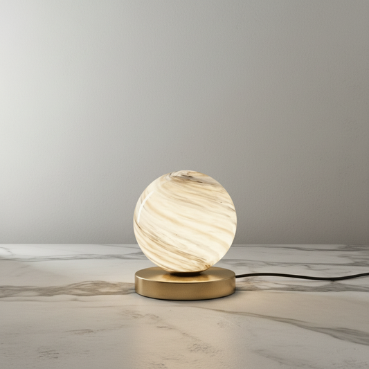 Jewel Table Lamp with brass base and marbled glass shade on bedside table in cozy bedroom