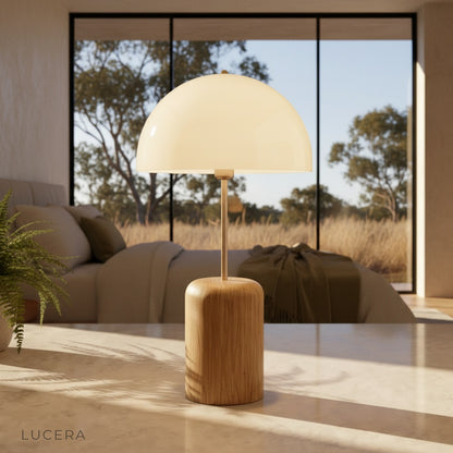 Ignescent Table Lamp with wooden base glowing on bedside table in cozy bedroom