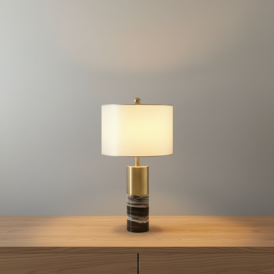 Essere Table Lamp glowing on marble side table in modern living room with soft ambient light