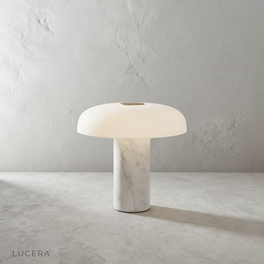 Beatrice table lamp with marble base and dome shade on a console in a bright living room