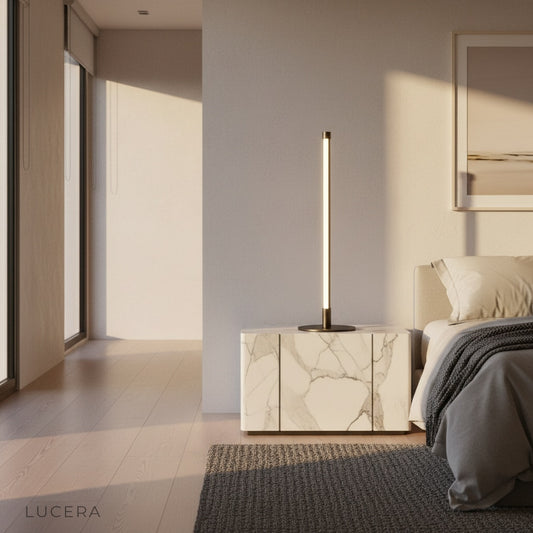 Pascal Table Lamp glowing warmly on a bedside table in a modern minimalist bedroom