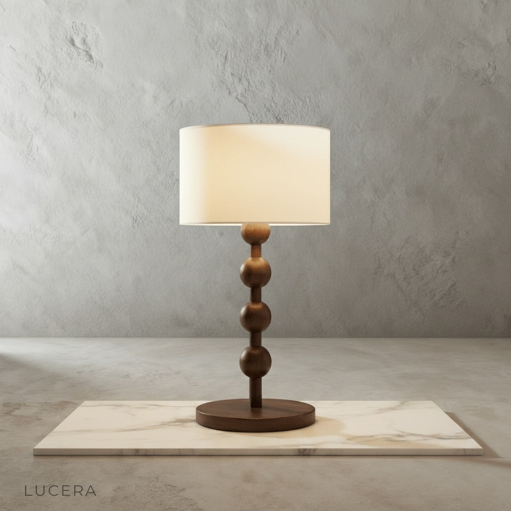 Boreal Table Lamp stacked wood spheres glowing on rustic wooden bedside table in cozy bedroom