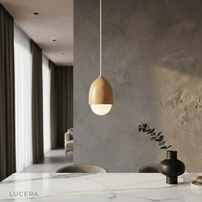 Holly wood-look pendant light illuminating a contemporary dining room with warm ambient glow