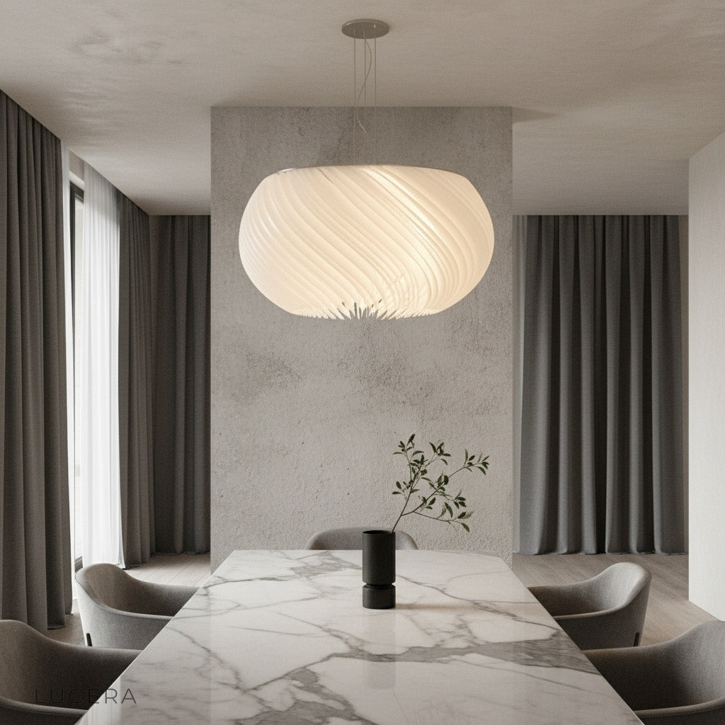 Theron chandelier glowing in modern dining room with white acrylic parchment shade