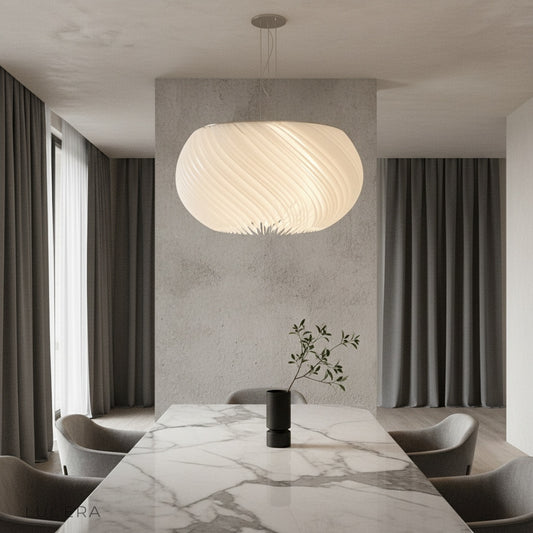 Theron chandelier glowing in modern dining room with white acrylic parchment shade