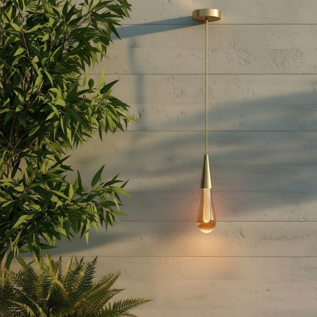 Beryl pendant light glowing over modern living room sofa with chrome gold finish