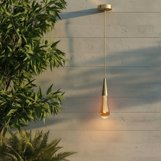 Beryl pendant light glowing over modern living room sofa with chrome gold finish