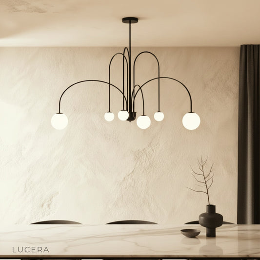 Unico Chandelier glowing above modern dining table in elegant living room
