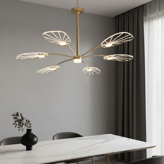 Vespera chandelier glowing in modern living room with gold finish and lotus leaf shades