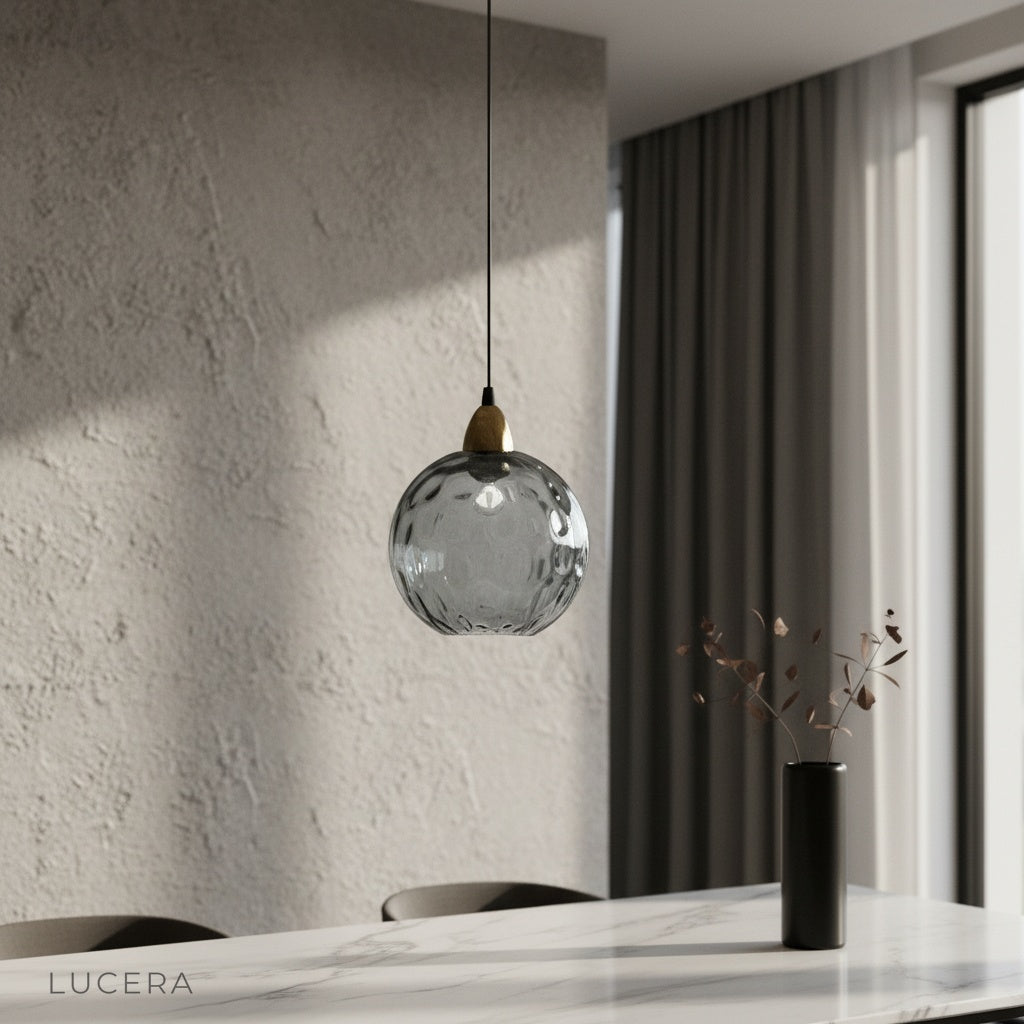 Kronos pendant light glowing above modern dining table in bright living room