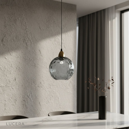 Kronos pendant light glowing above modern dining table in bright living room