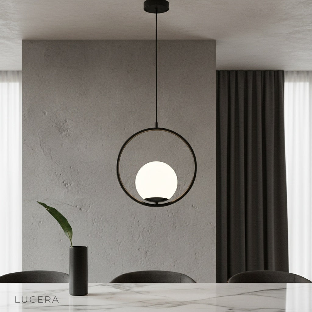 Zigolo pendant light illuminating modern living room with brass finish