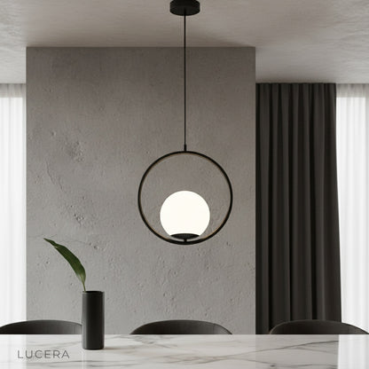 Zigolo pendant light illuminating modern living room with brass finish