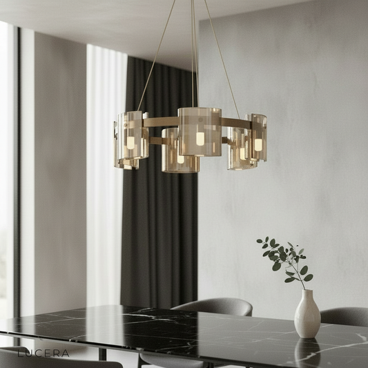 Cardinal Chandelier by Lucera glowing above a modern dining table with clear glass rings