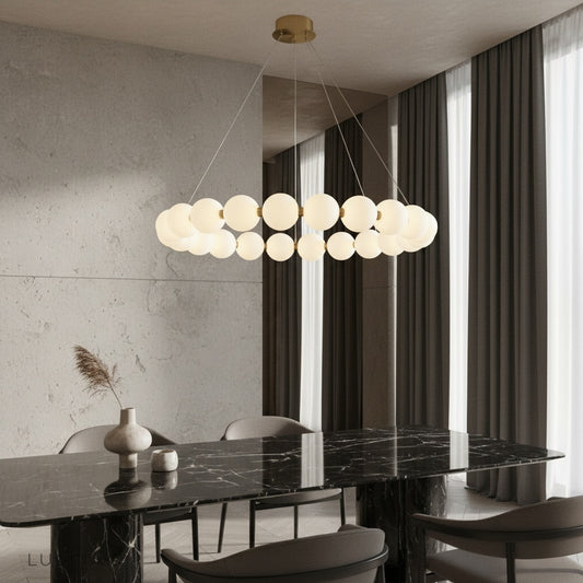 Ignite Pearlescent Chandelier glowing in modern living room with copper frame and gold finish