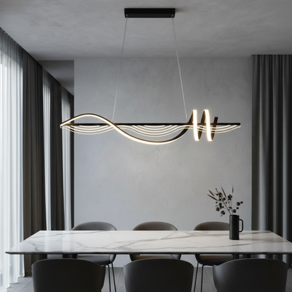 Ulysse LED chandelier with wavy aluminum body glowing in modern living room