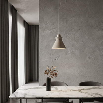 Jazzle pendant light with yellow travertine shade glowing above a modern wooden dining table in a bright living room