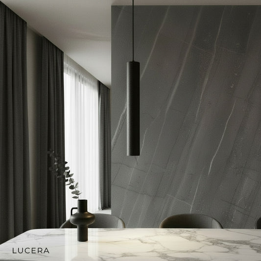 Auroral concrete pendant light illuminating a modern dining room with black cords