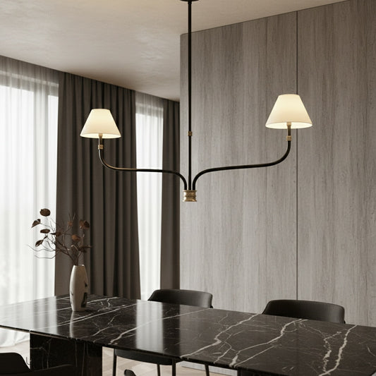 Dusk Chandelier with six cloth shades glowing warmly above a modern dining table in an elegant living room