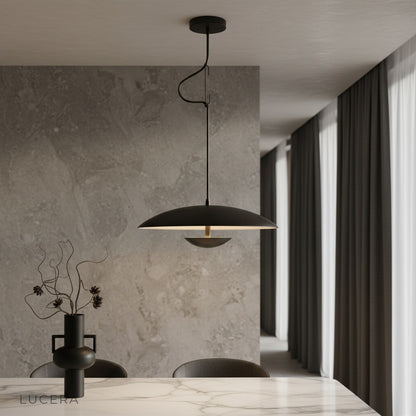 Cinder Pendant Light by Lucera hanging above a kitchen island in a modern minimalist home