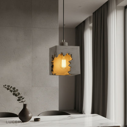 Enthrall concrete pendant light illuminating a modern kitchen island with warm ambient glow