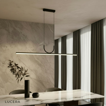 Honeysuckle linear pendant light illuminating a modern kitchen island in a bright open-concept home
