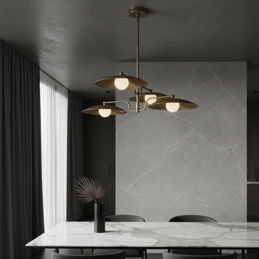 Stellar Brass Chandelier glowing above a modern dining table with curved arms and dome shades