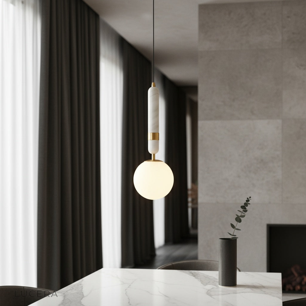Groove pendant light over marble kitchen island with warm copper glow