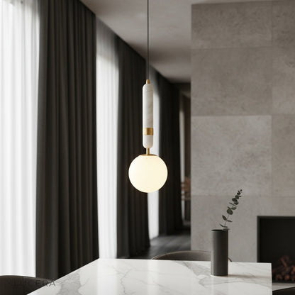 Groove pendant light over marble kitchen island with warm copper glow