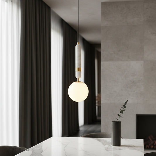 Groove pendant light over marble kitchen island with warm copper glow