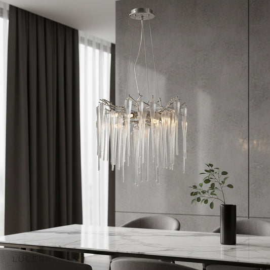 Dolcetto round chandelier glowing above a modern dining table in a Nordic-style living room