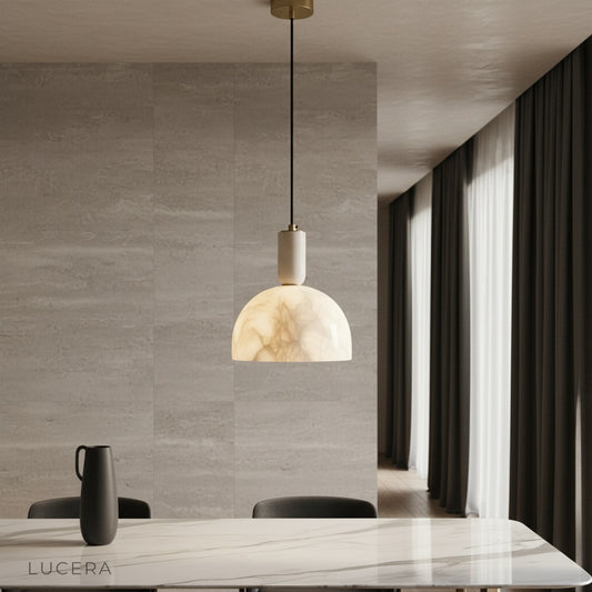 Midas alabaster pendant light glowing softly above a modern dining table in a serene living room