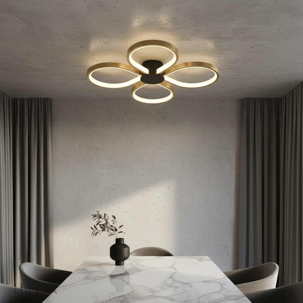 modern brass ceiling light with four LED rings illuminating a contemporary living room