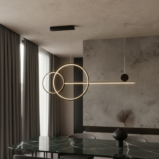 Brumal pendant light with black and gold rings illuminating a modern living room