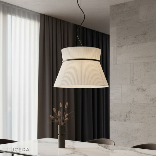 Ilaria pendant light glowing warmly over a modern dining room table in a cozy Nordic-inspired home
