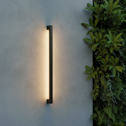 modern indigo outdoor wall lamp glowing on contemporary patio at dusk