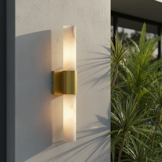 Umbra Alabaster wall sconce with copper frame glowing in a modern bedroom