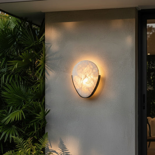 Borealis Alabaster Wall Sconce glowing softly in a modern bedroom hallway