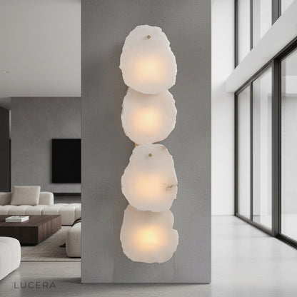 Esker wall lamp with alabaster marble and copper glowing in a modern living room
