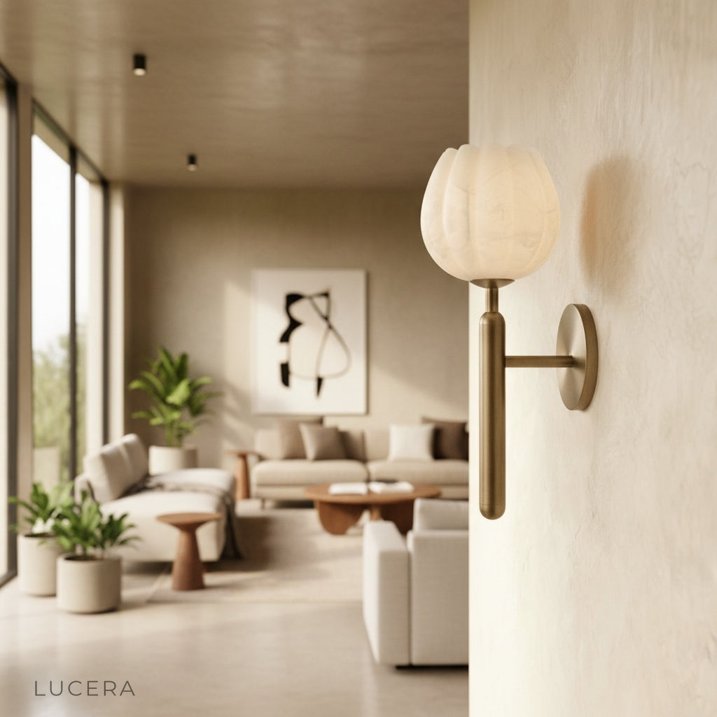 Madeira alabaster wall lamp glowing warmly above a bedside table in a serene bedroom