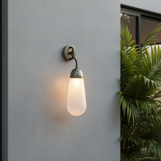 modern copper wall sconce with frosted glass shade in a cozy bedroom