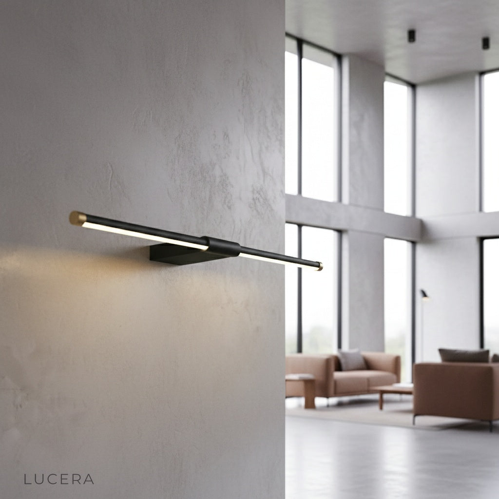 Tranquility Wall Lamp brass accent illuminating a modern bathroom vanity mirror