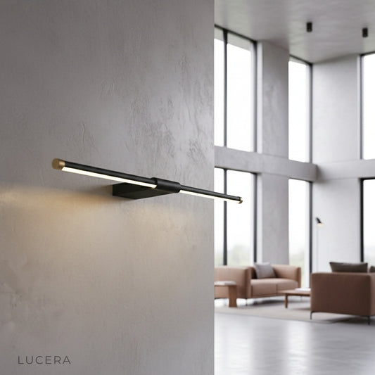 Tranquility Wall Lamp brass accent illuminating a modern bathroom vanity mirror