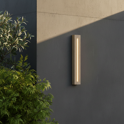 Yves travertine wall lamp glowing in modern living room with warm ambient light
